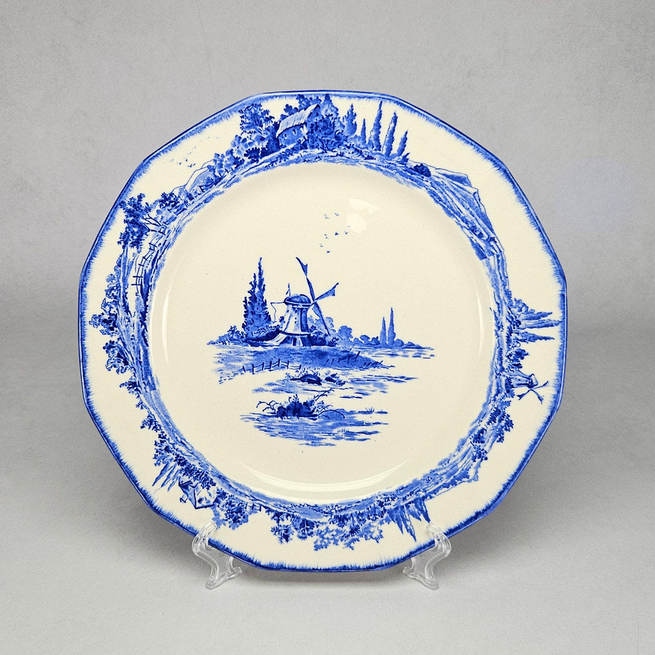 Royal Doulton Norfolk Blue D4209 scalloped plate with central windmill landscape scene, rural countryside border and blue edge detail on a cream earthenware body, displayed on a clear plate stand