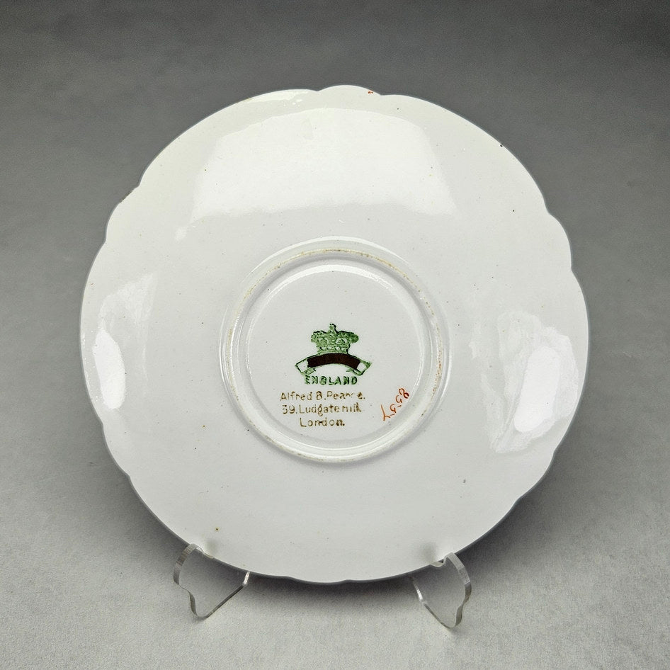 Underside of Pearce saucer with crowned London retailer mark