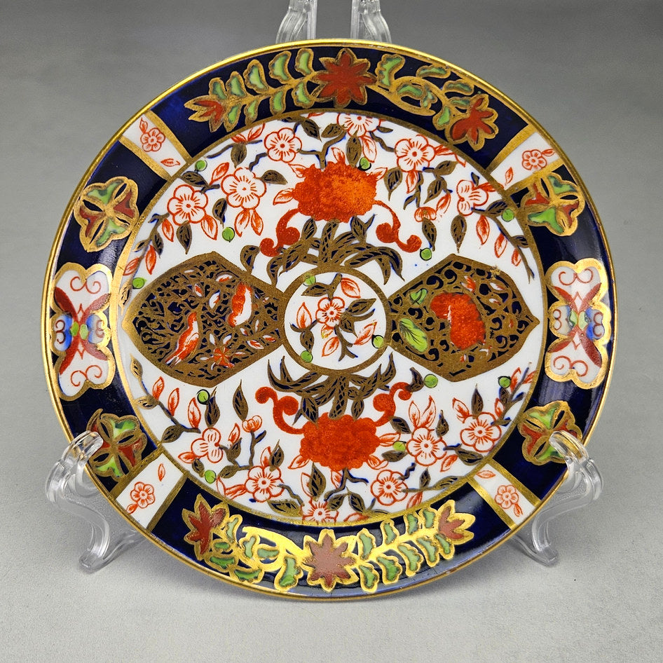 Derby Crown Imari side plate showing cobalt and iron-red floral panels