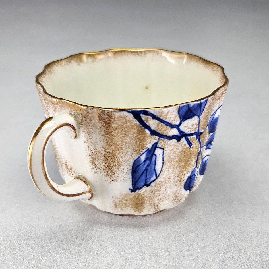 Royal Doulton C1800 teacup showing blue flowers and mottled gilding
