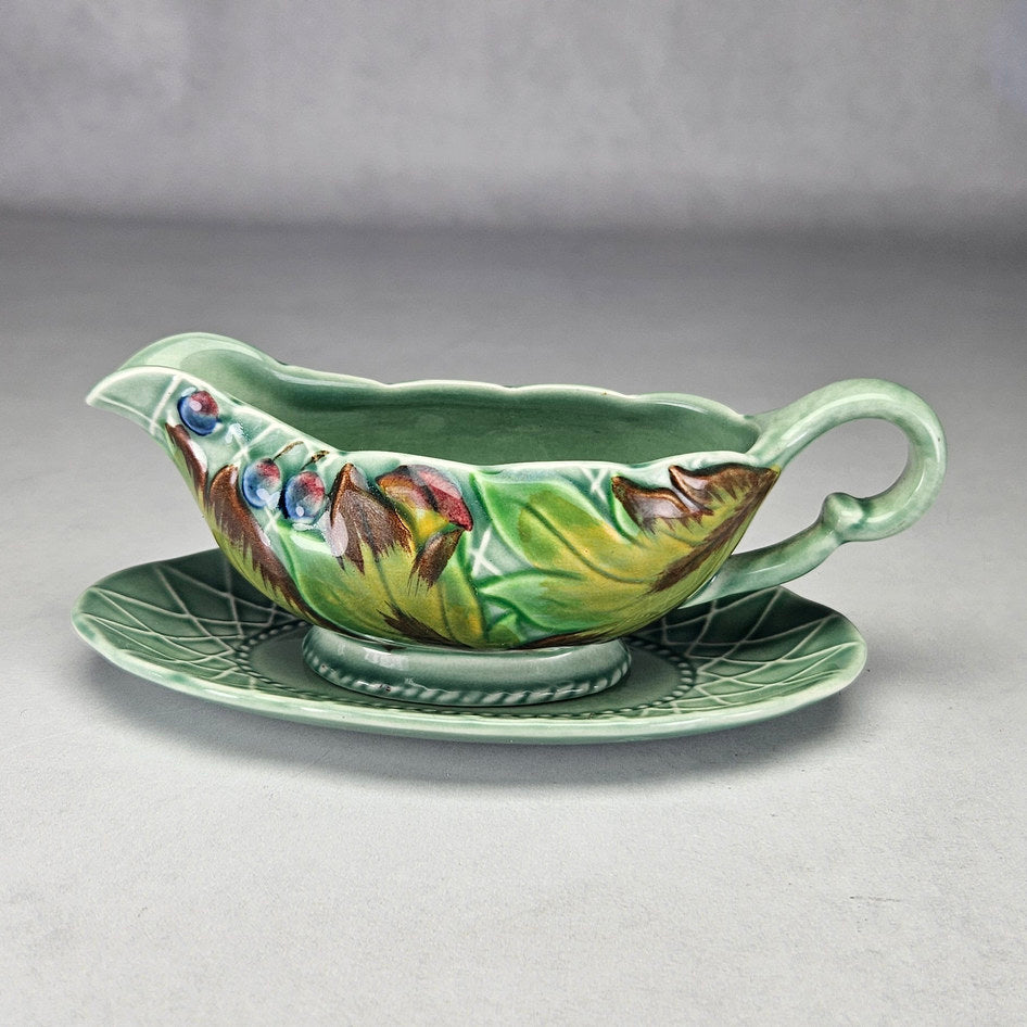 Clarice Cliff Newport leaf and berry sauce boat with stand, photograph 1 of this collectible ceramic piece