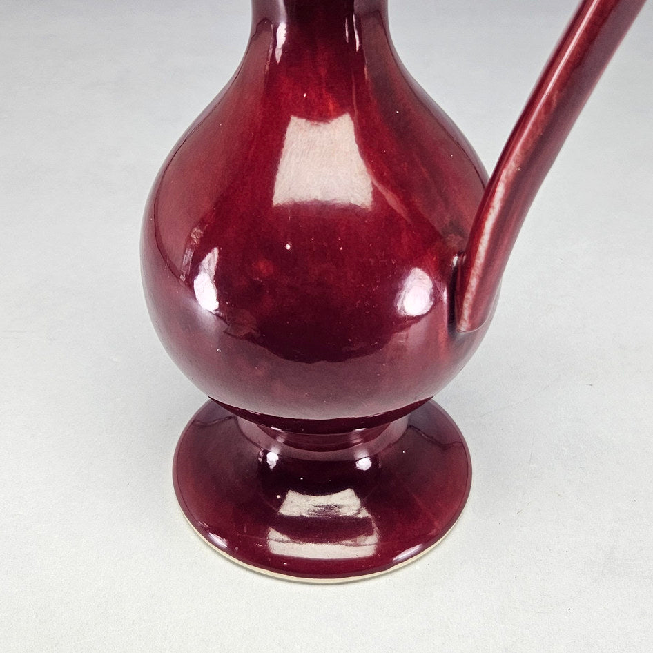 Drostdy Ware burgundy pedestal ewer showing glossy wine-red glaze