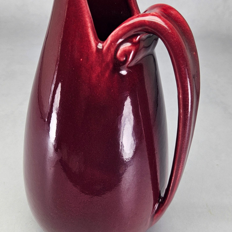 Drostdy Ware burgundy tall ewer showing glossy red surface