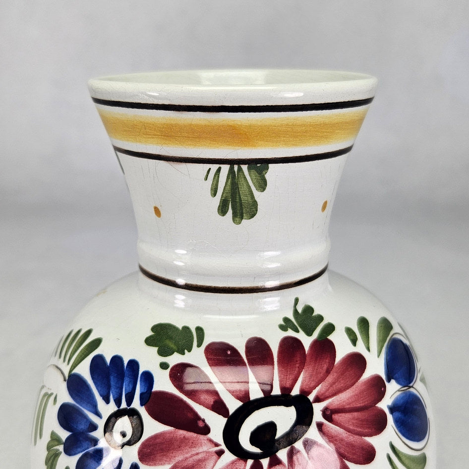 Dutch floral vase close-up showing yellow neck band and burgundy petals
