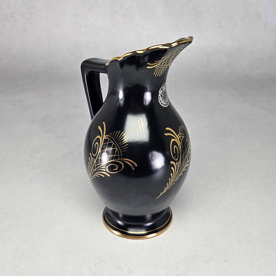 Flora Gouda Ora black jug showing gilt motifs and factory label
