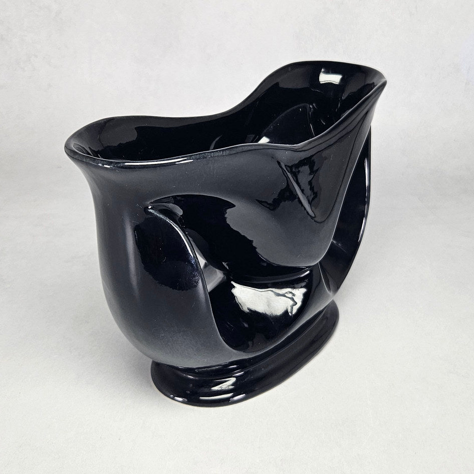 Lucia Ware black ceramic mantel vase with pierced teardrop openings