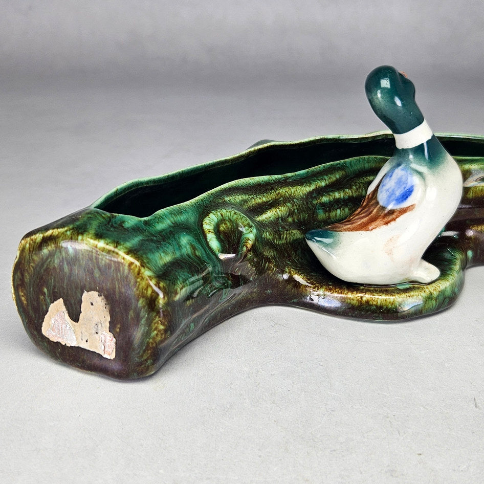 Lucia Ware duck log planter showing multicoloured ceramic bird