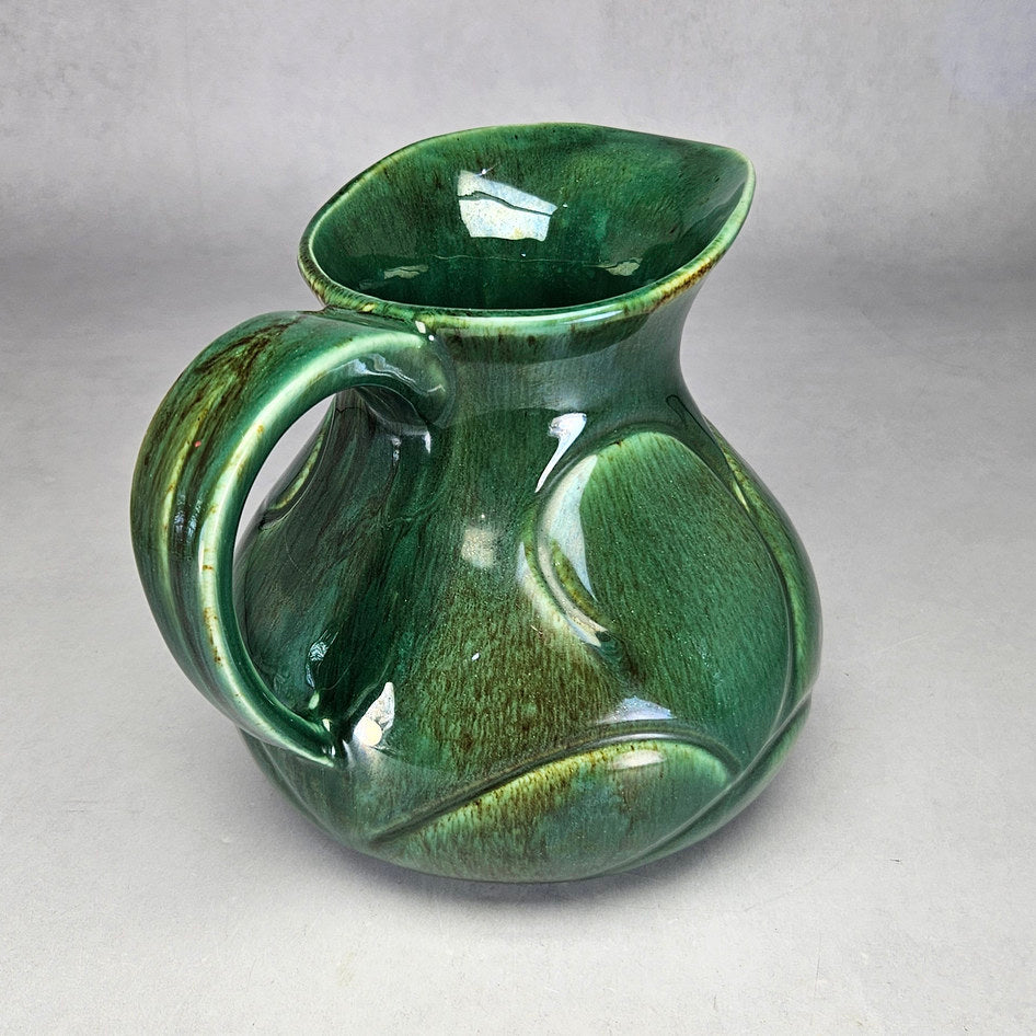 Lucia Ware green scroll jug showing curved moulded panels