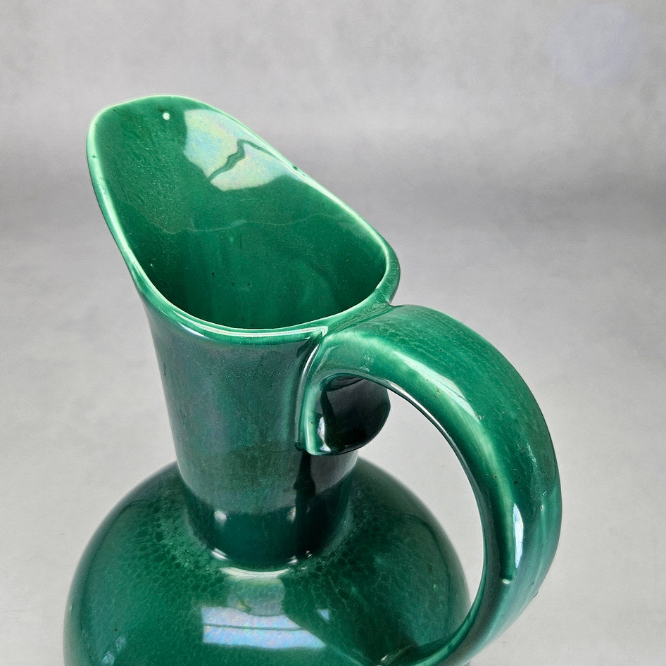 Lucia Ware green tall-neck ewer viewed towards glazed opening