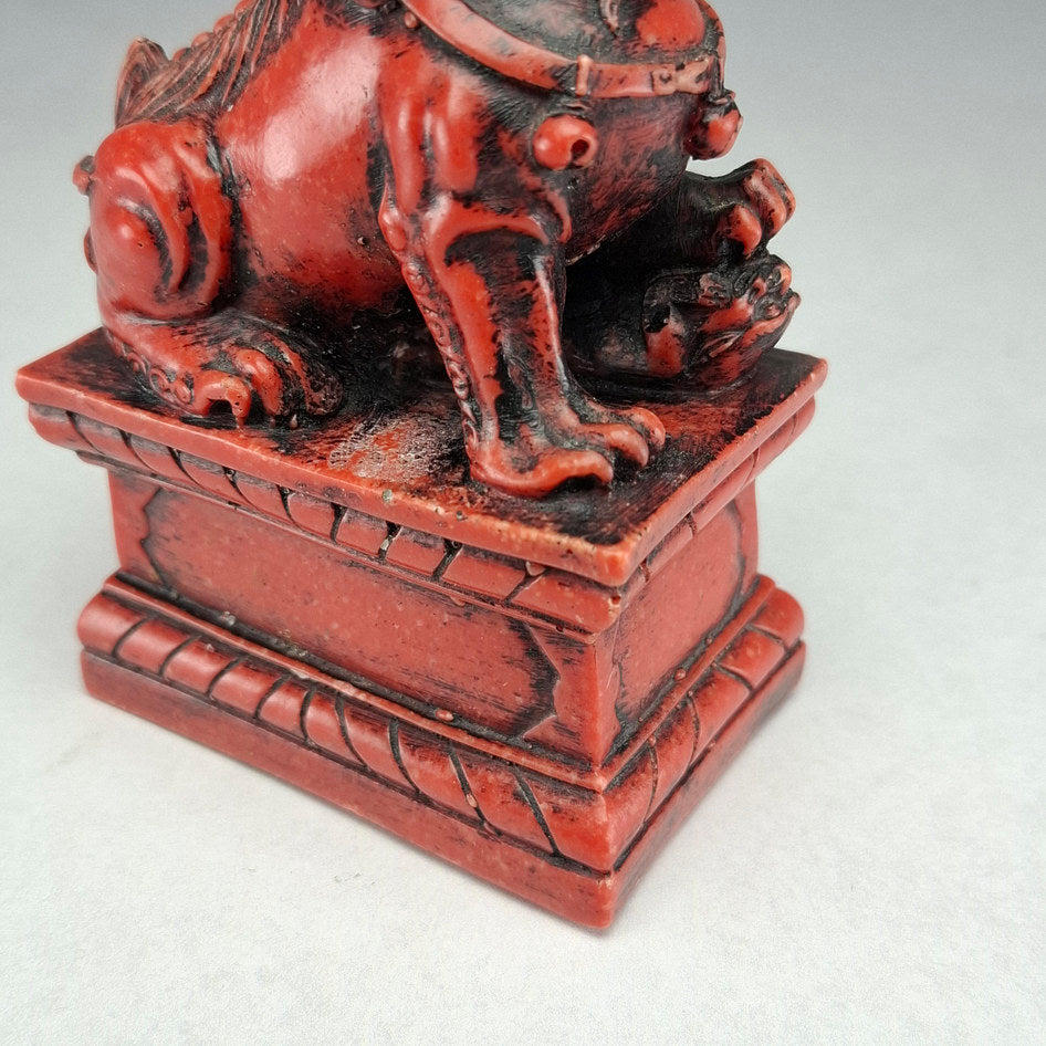 Pair of Red and Black Cast Stone Chinese Guardian Lions