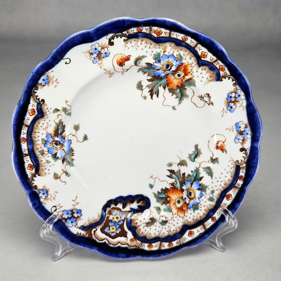 Plant Rococo and Poppy side plate showing cobalt border and orange flowers