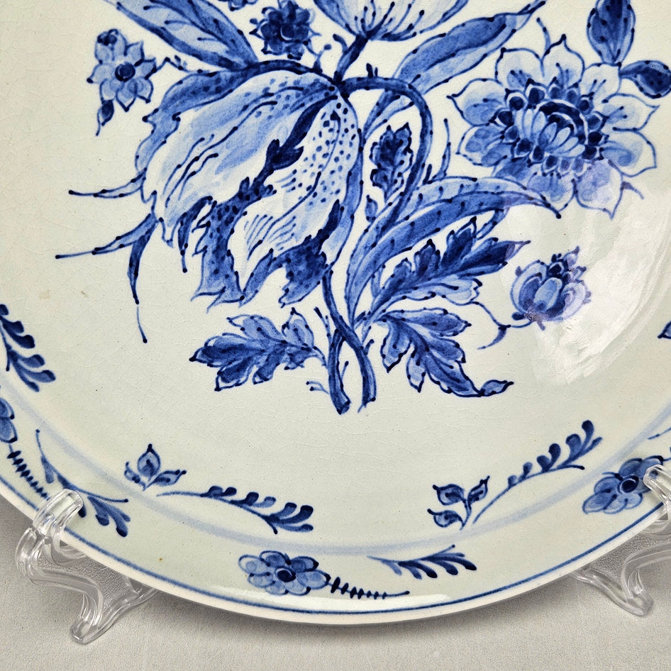 Royal Delft wall plate detail showing lower foliage and rim decoration