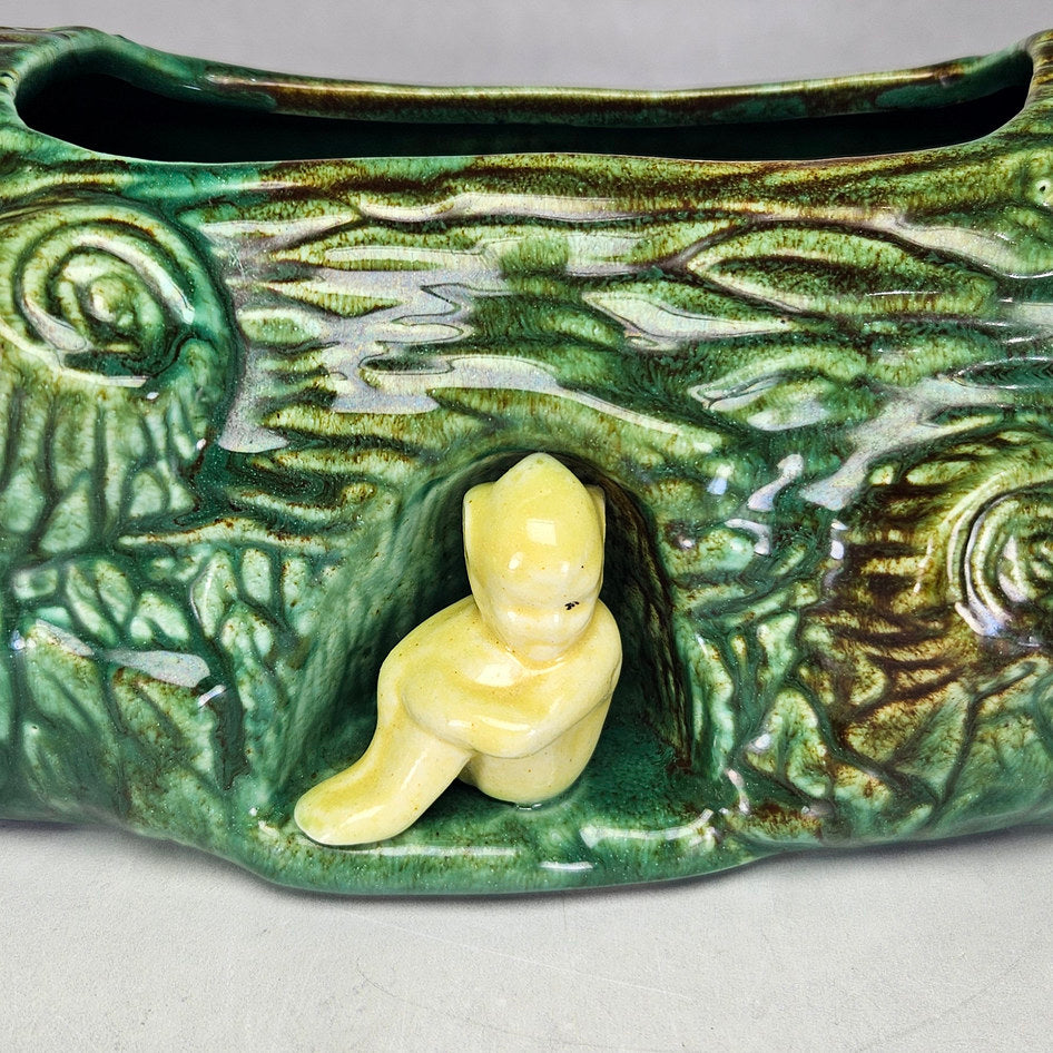 Vermont green log planter showing yellow figure and bark