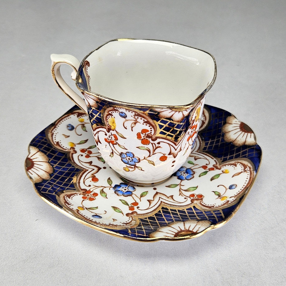Reverse view of Flosmaron cup with ornate scroll handle