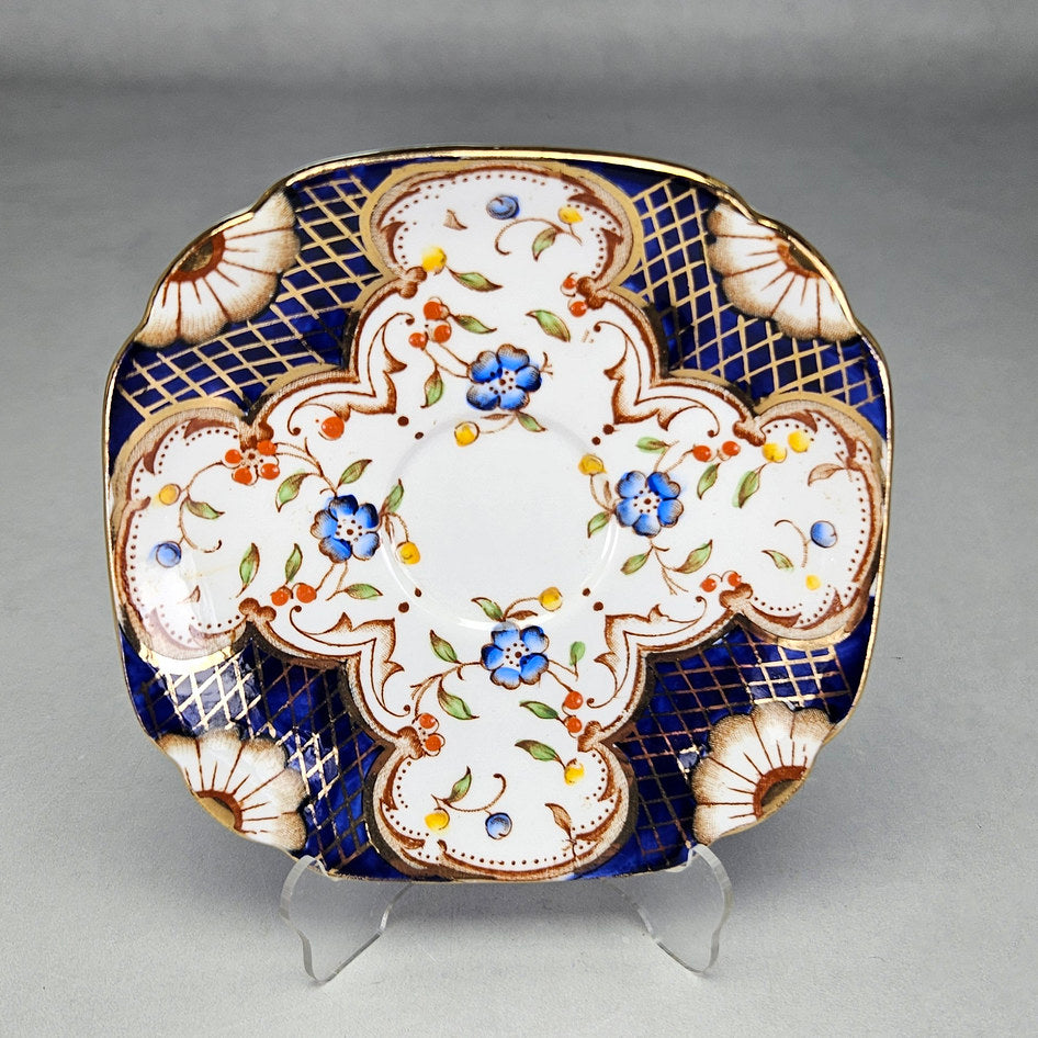 Flosmaron saucer showing colourful flowers and scalloped rim