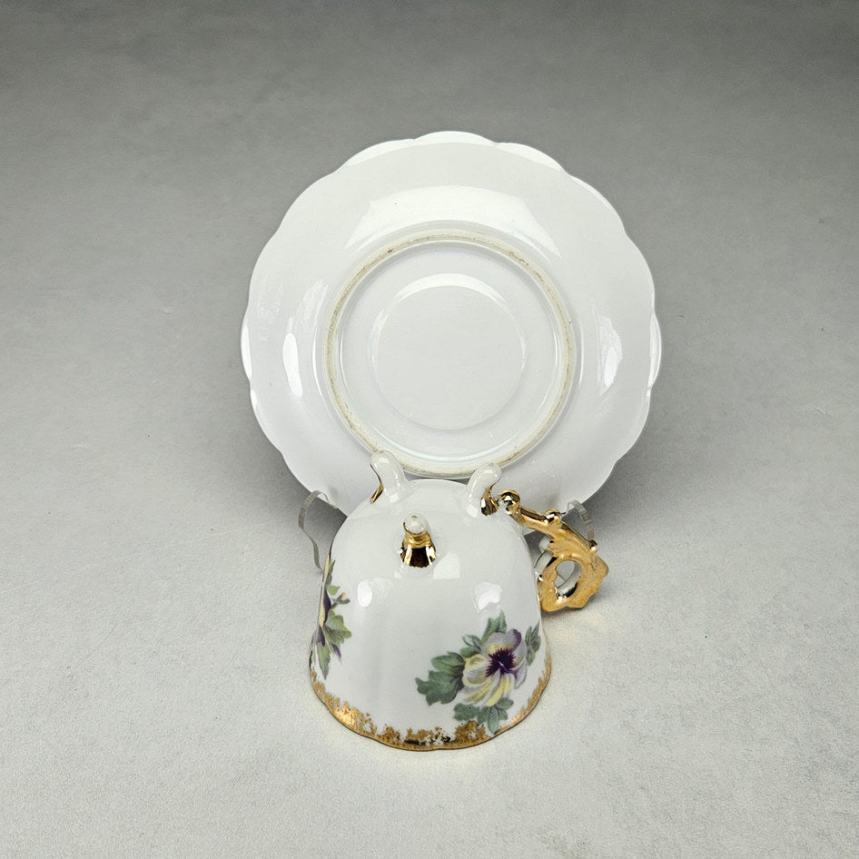 Undersides of unmarked footed pansy cup and saucer