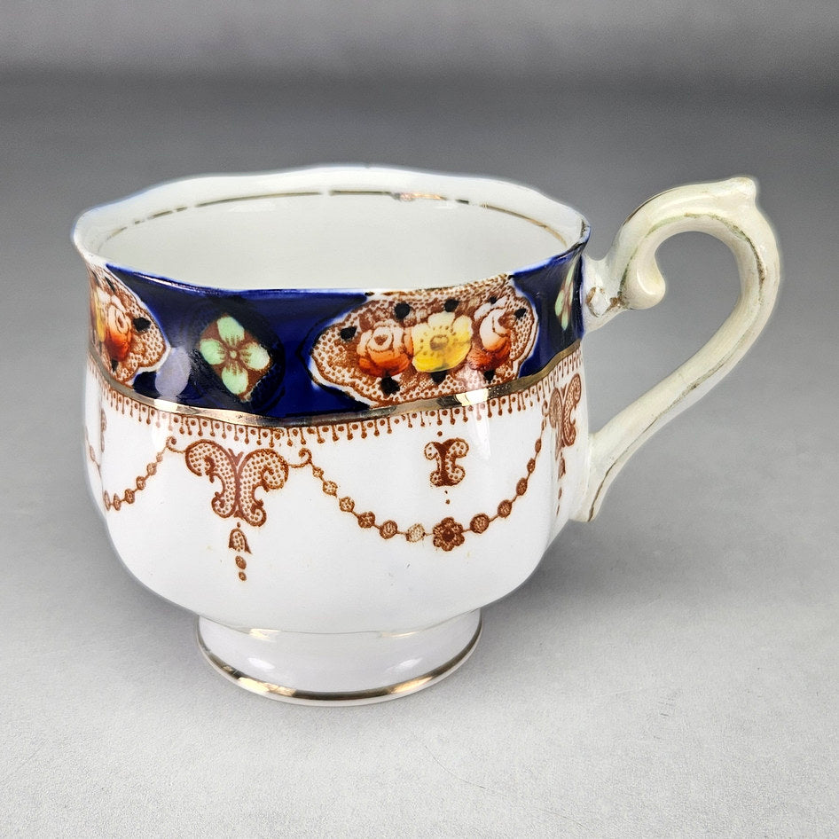 Royal Albert Crown China teacup with cobalt floral border