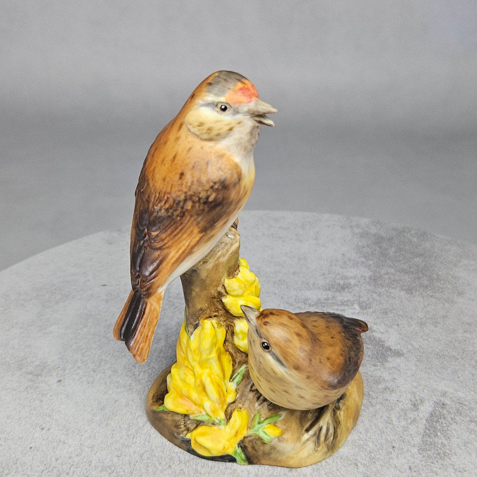 Close up of linnets figurine's painted feather detail