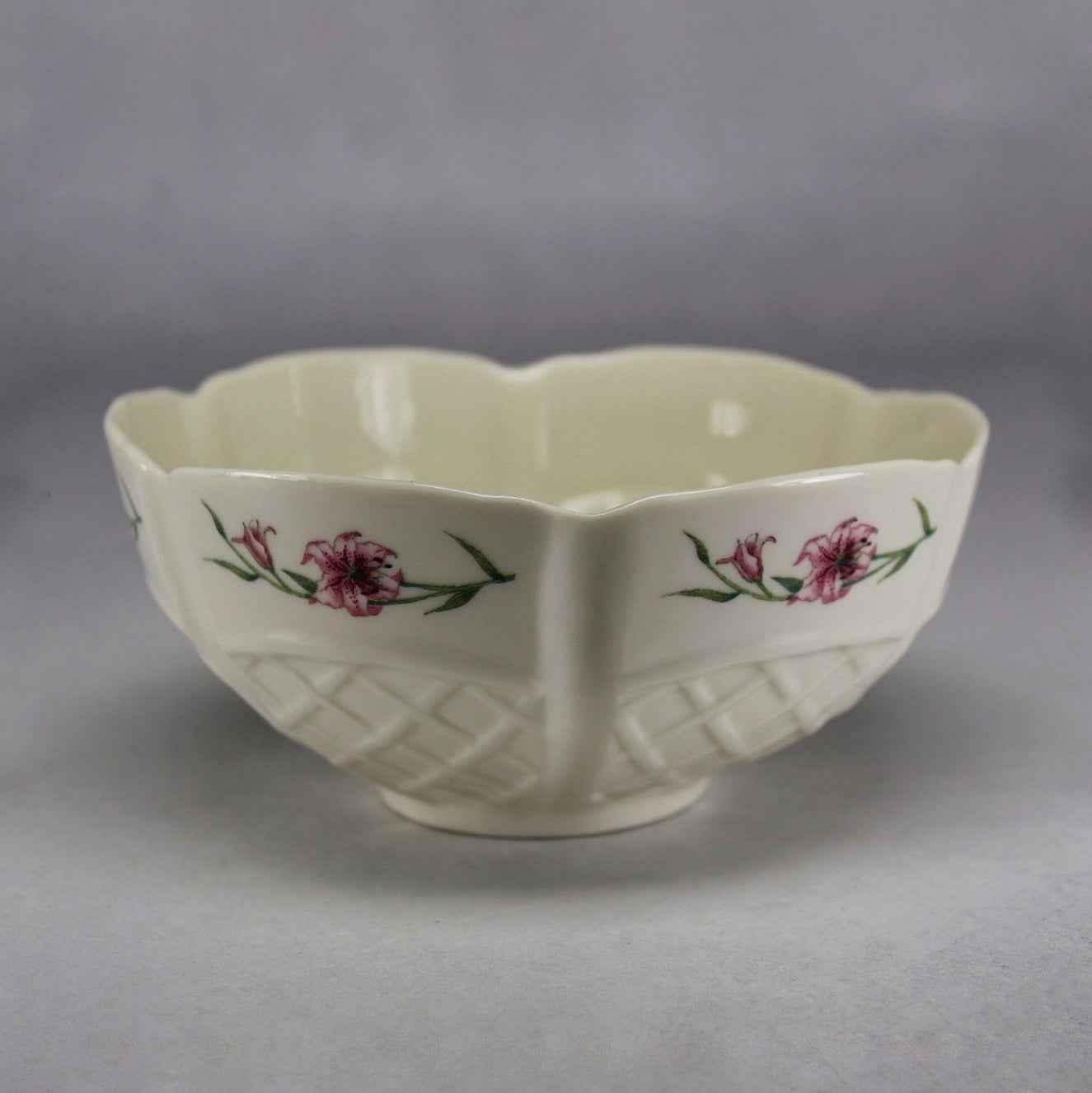 Belleek Ireland cream basket weave sugar basin with hand-painted pink lily motif showing the delicate parian porcelain and signature lattice moulding