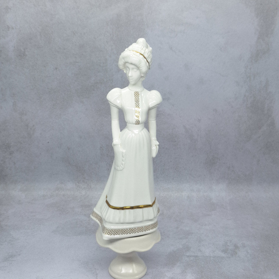 Spode Sarah bone china lady figurine by Pauline Shone, white porcelain with gold detail, full length view showing period dress and hat
