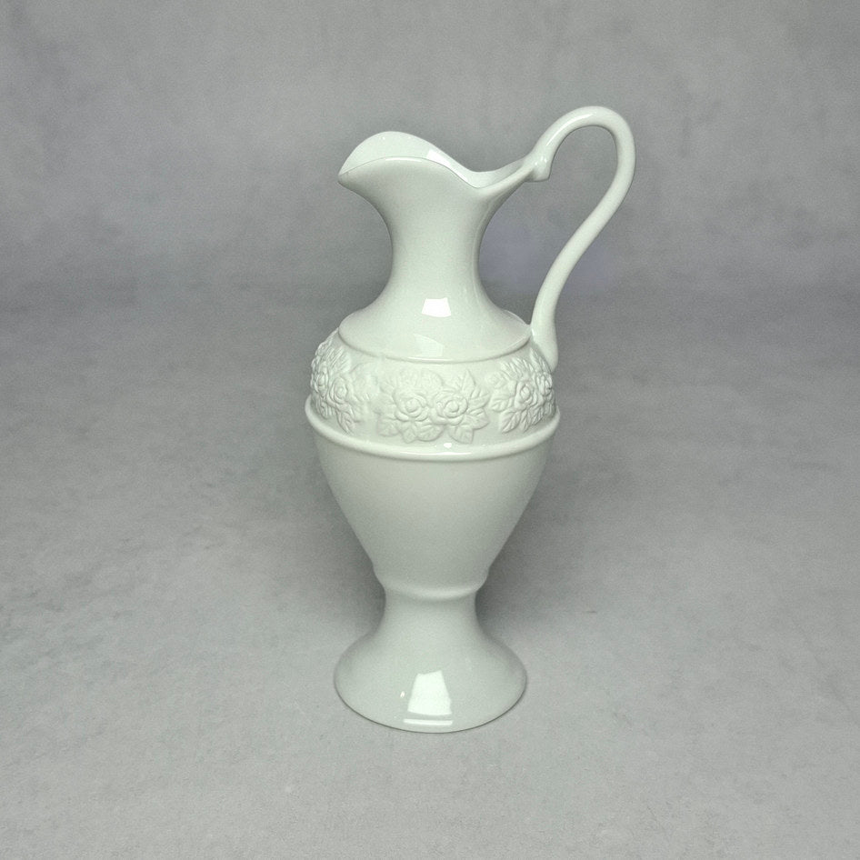 Vintage white bone china pitcher with embossed floral band showing the translucent quality and fine finish characteristic of bone china