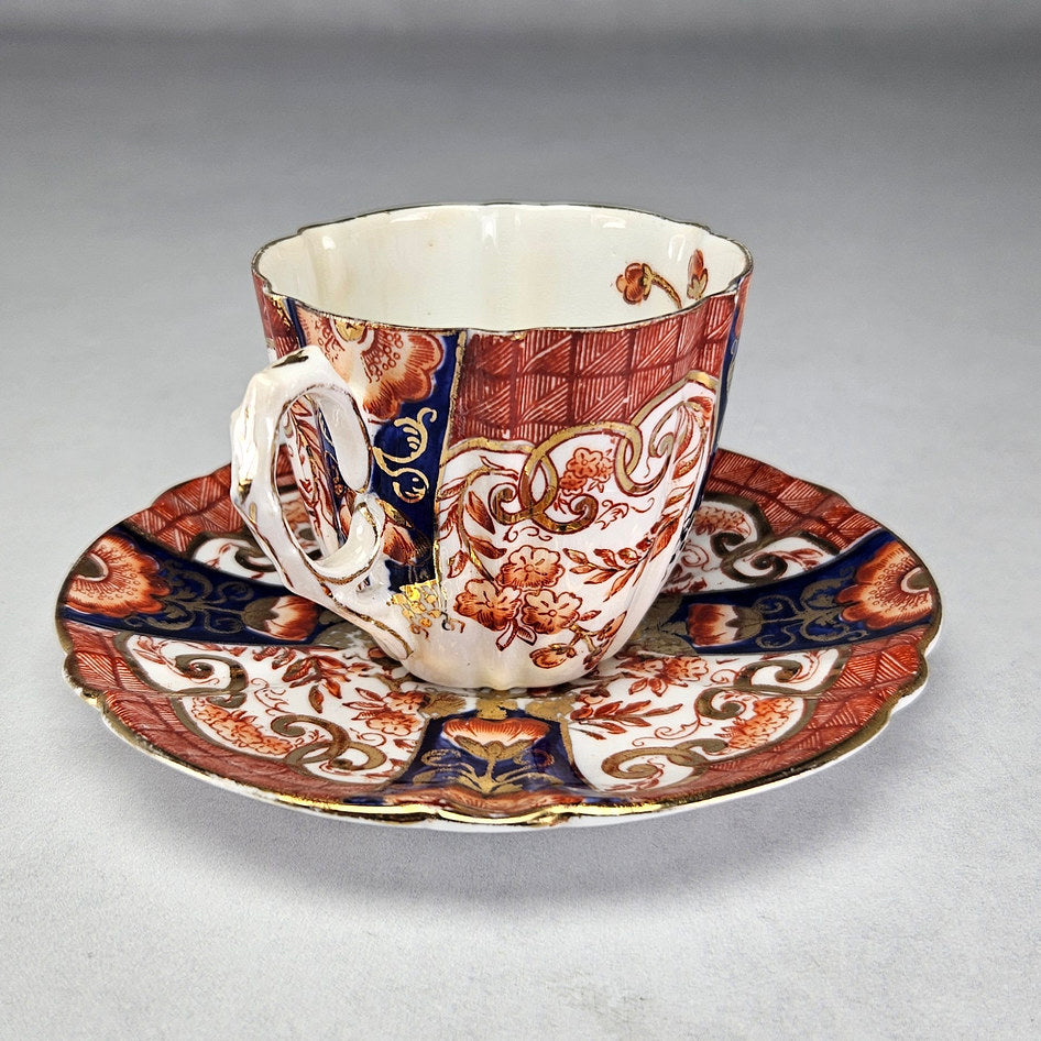 Pearce cup and saucer with iron-red flowers and cobalt panels