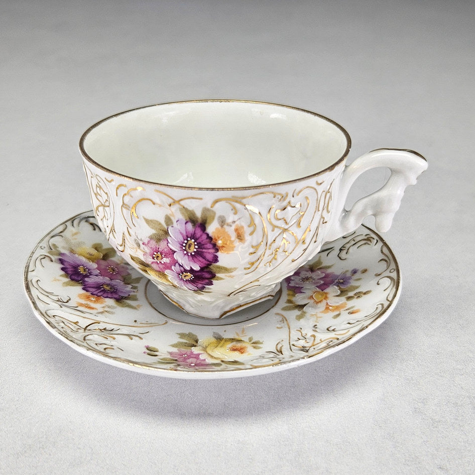 Carl Tielsch floral cup and saucer with moulded scrollwork