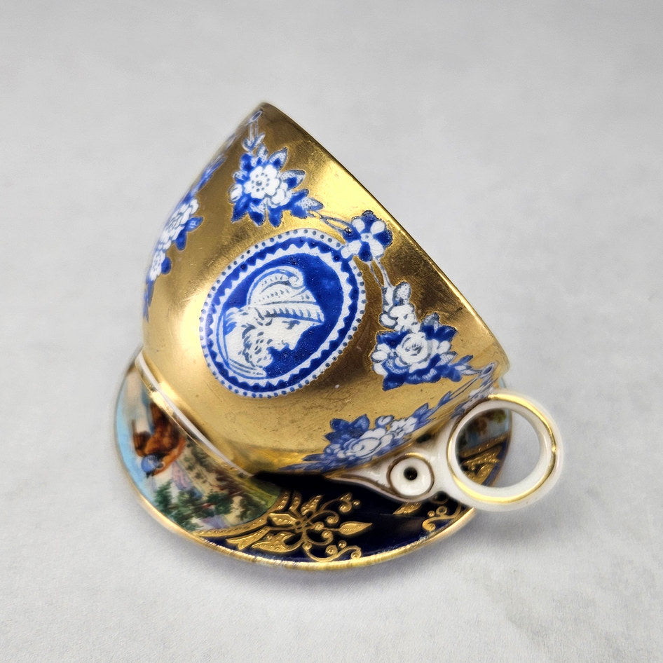 Coalport saucer with pastoral panels and raised gilding