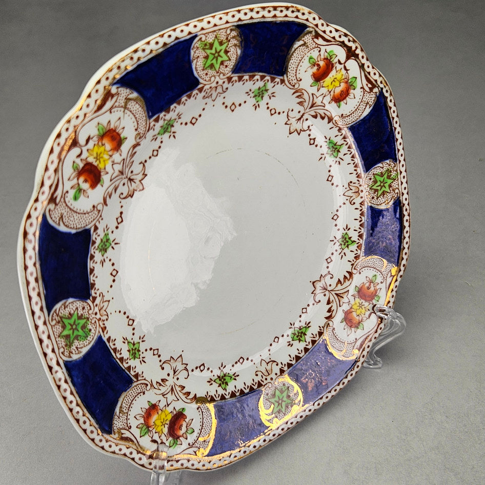 Doric side plate with blue panels and green motifs