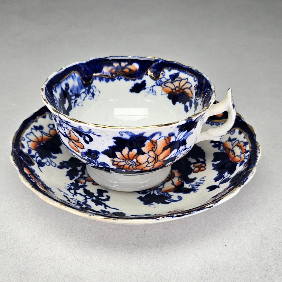 Unmarked flow blue cup and saucer with orange flowers