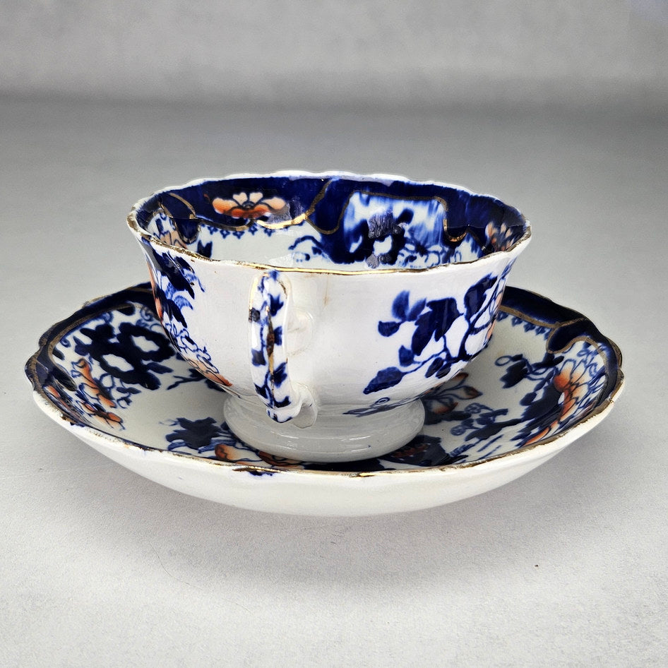 Flow blue floral cup and scalloped matching saucer