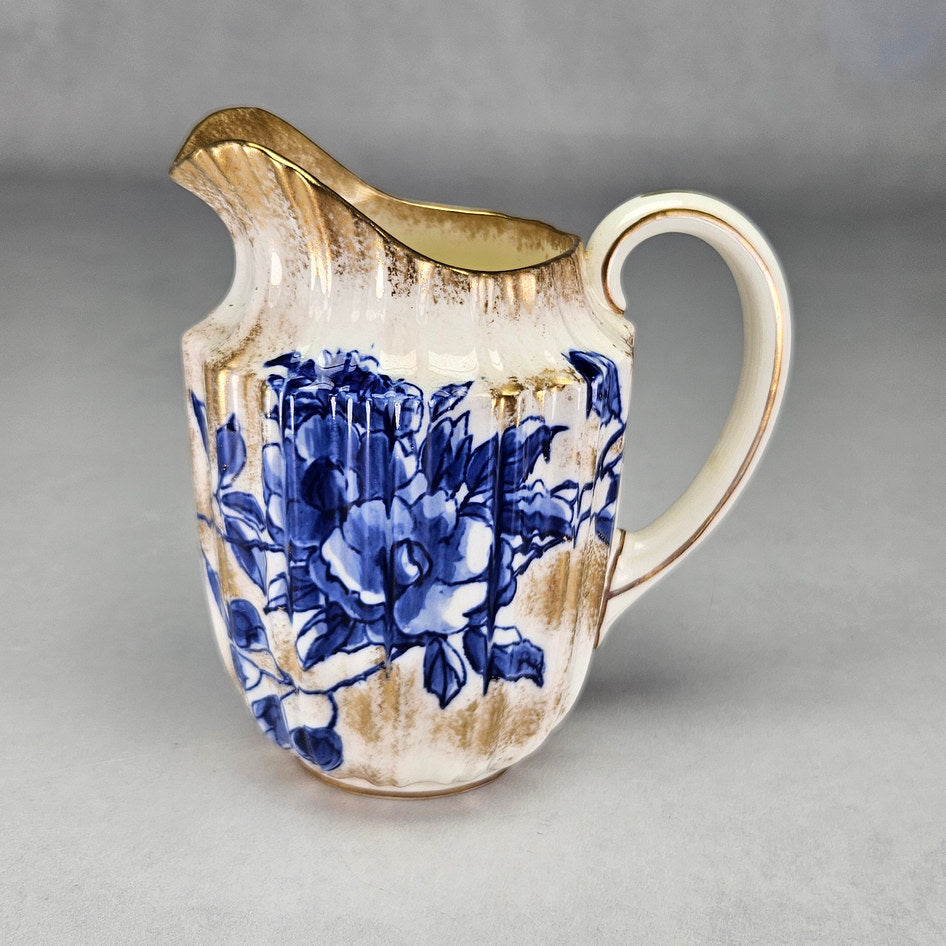 Royal Doulton C1800 cream jug with blue flowers and gilt finish