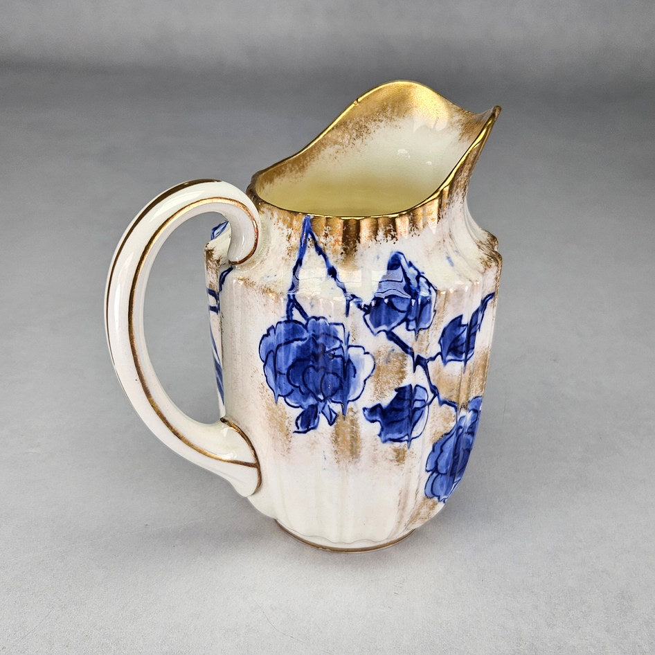 Royal Doulton C1800 cream jug showing blue flowers and gilt finish