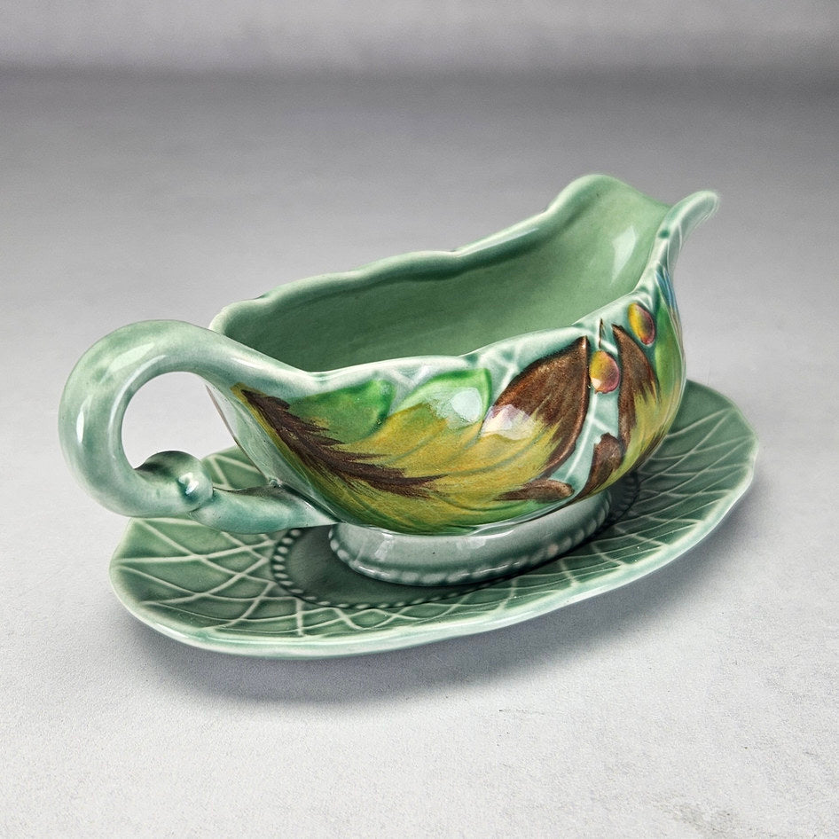 Clarice Cliff Newport leaf and berry sauce boat with stand, photograph 2 of this collectible ceramic piece