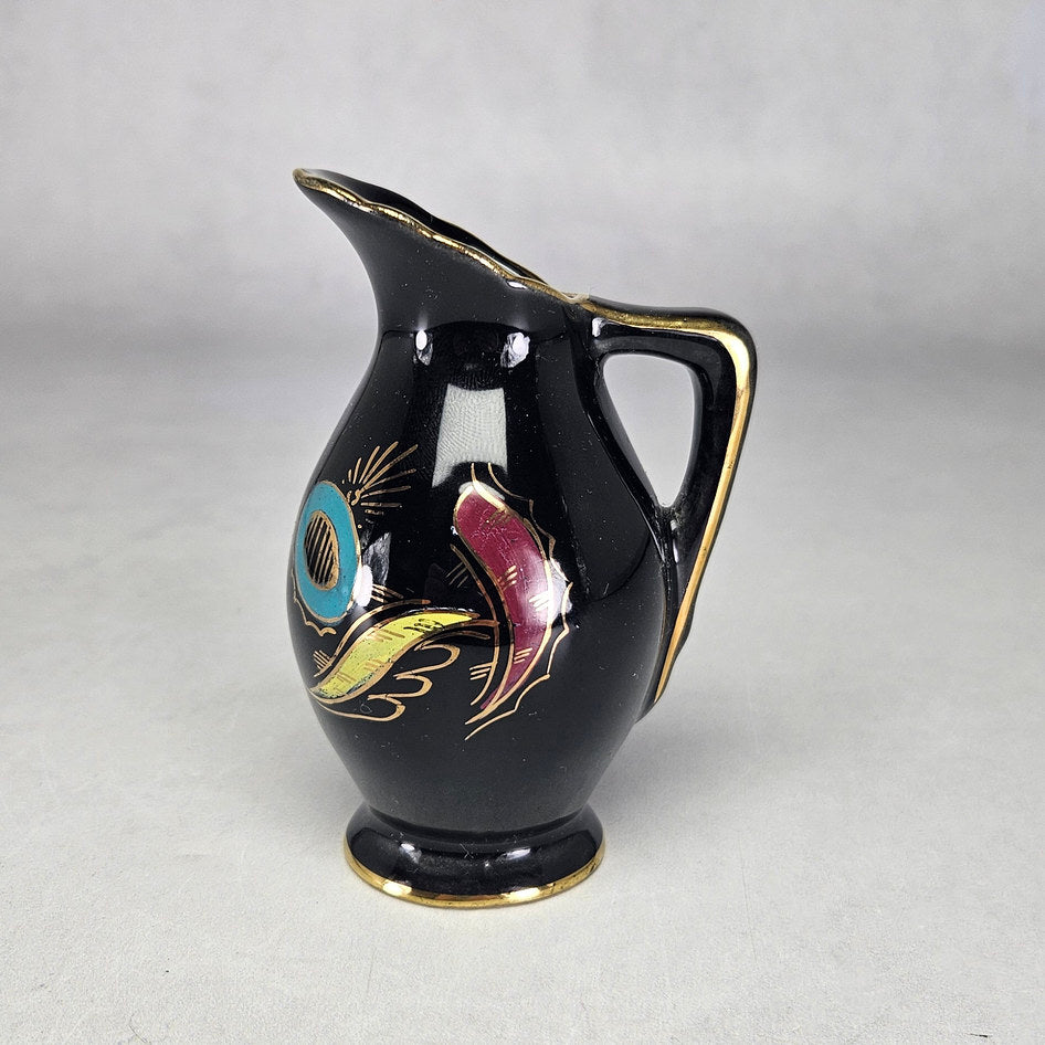 Flora Gouda Nova miniature black jug with colourful gilt decoration