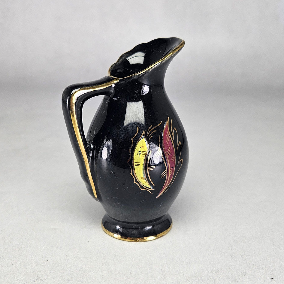 Flora Gouda Nova miniature jug showing gilt handle and coloured motifs