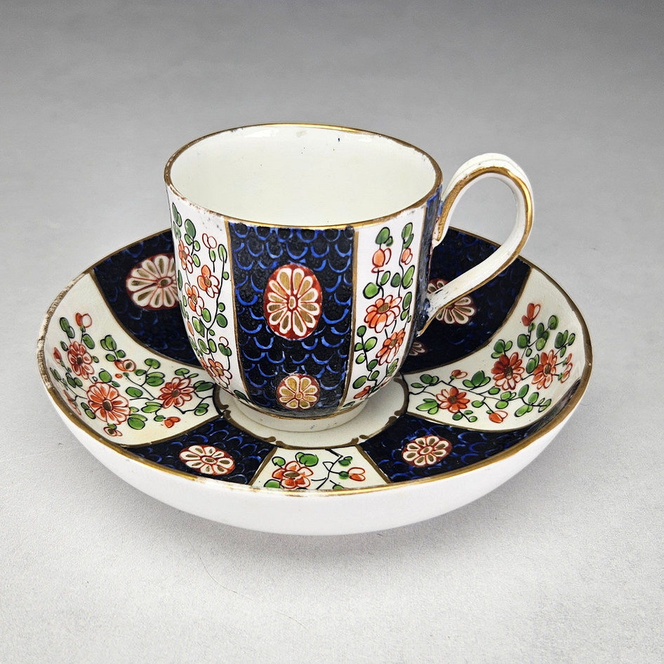 Worcester blue scale cup and saucer with enamelled flowers