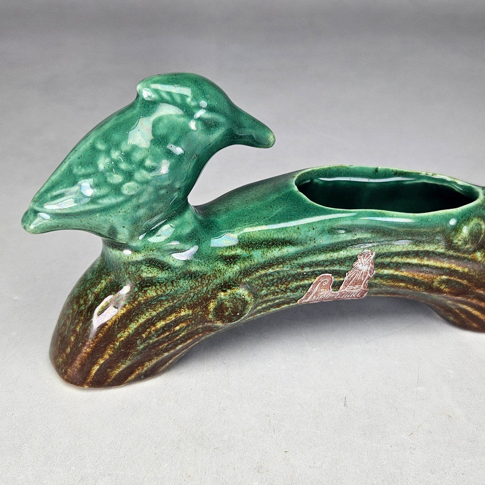 Lucia Ware bird log planter showing textured wings and bark