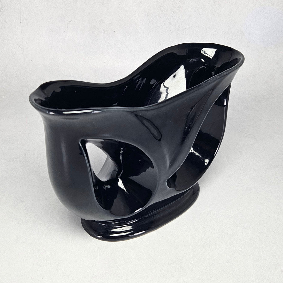 Lucia Ware black ceramic mantel vase with pierced teardrop openings
