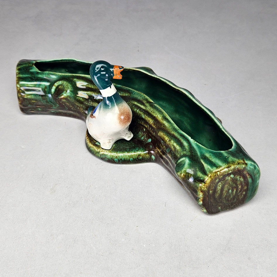 Lucia Ware duck log planter showing curved textured reverse