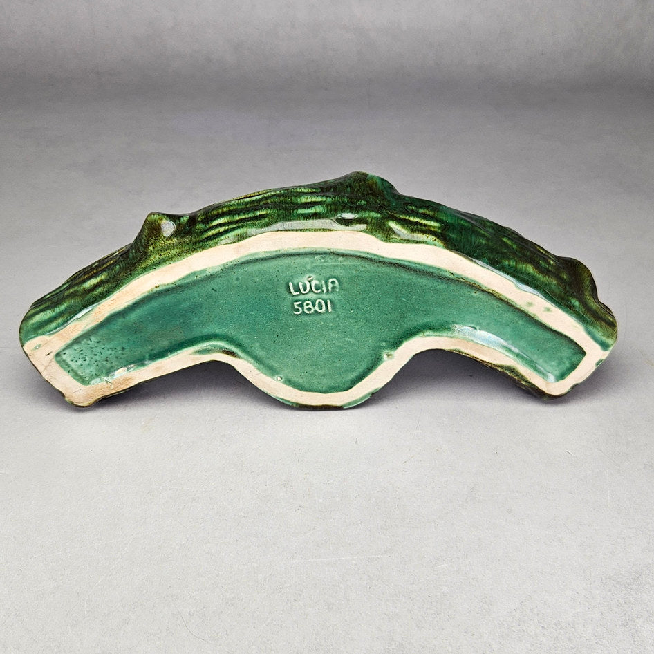 Lucia Ware duck log planter underside showing LUCIA marking