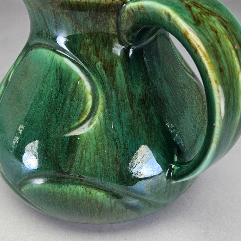 Lucia Ware green scroll jug showing brown-streaked glaze detail