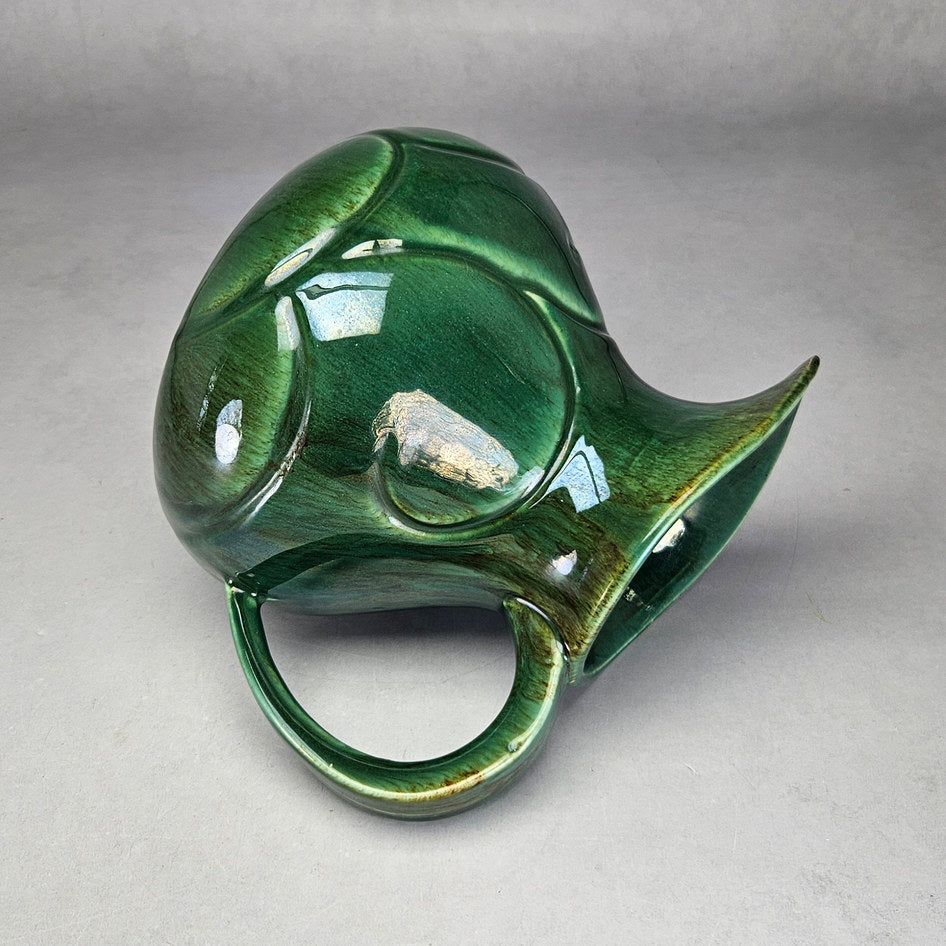 Lucia Ware green scroll jug showing rounded ceramic profile