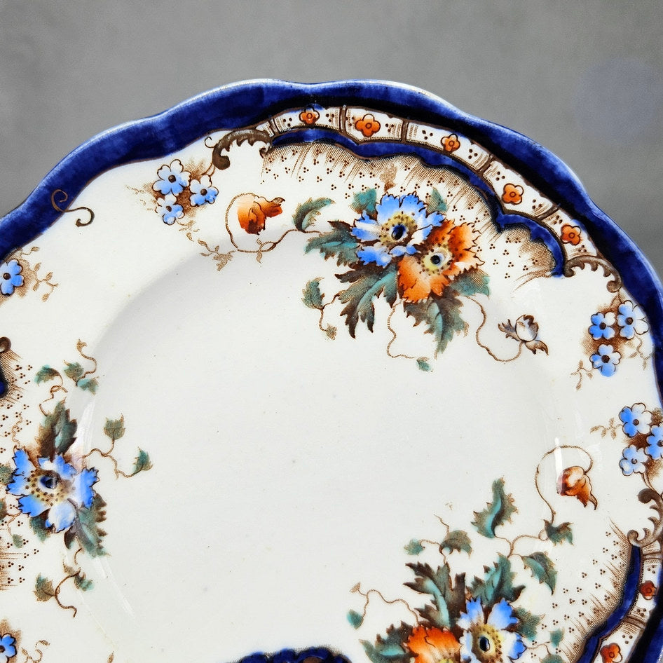 Plant Rococo and Poppy side plate with visible decorative details
