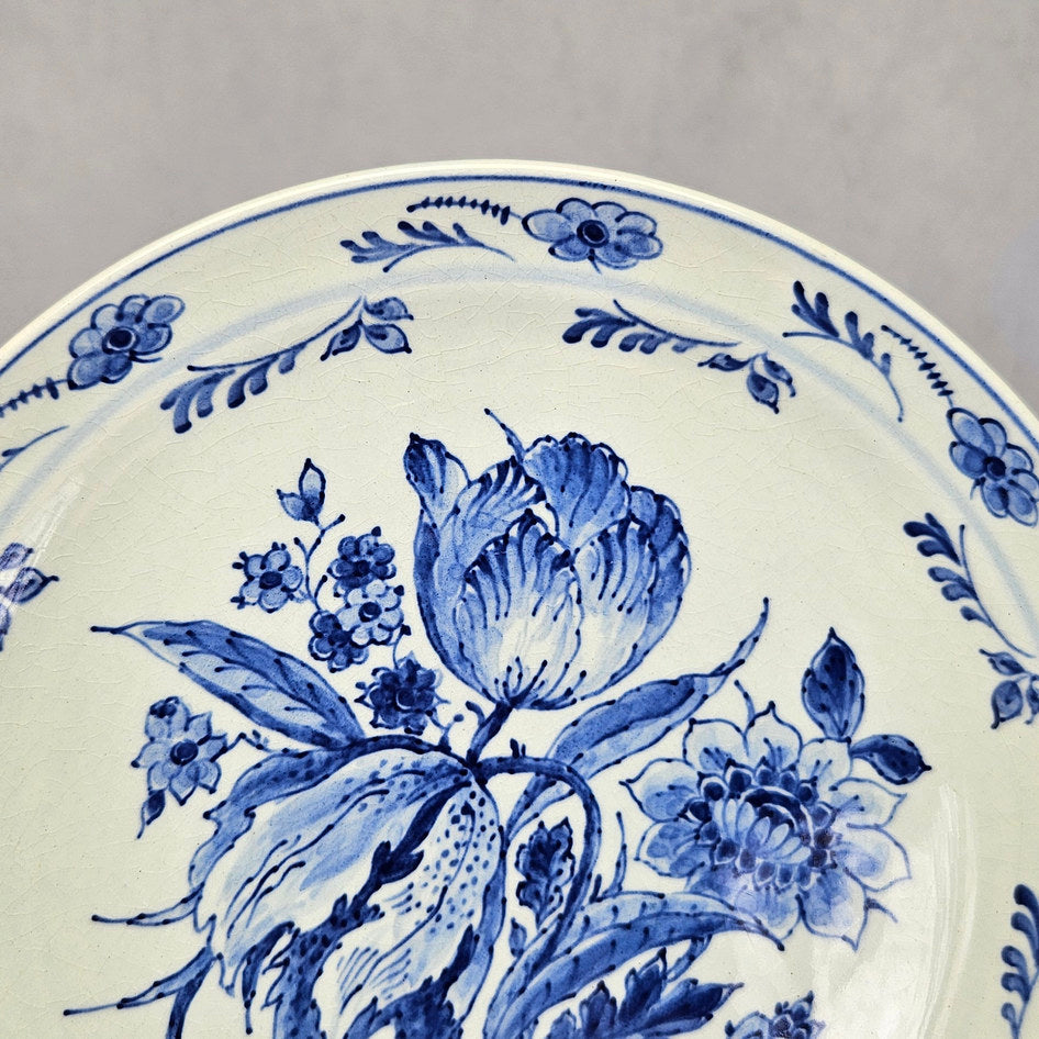 Royal Delft wall plate detail showing upper flower and floral border