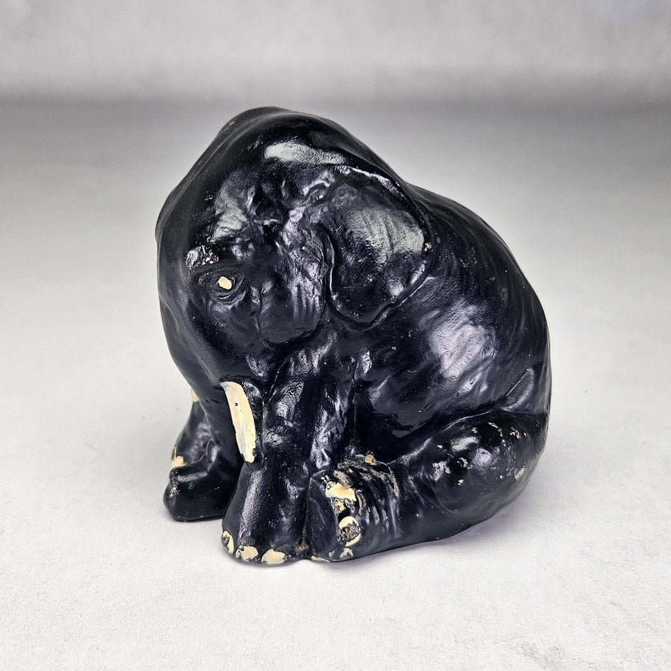 Black seated English ceramic elephant attributed to Sylvac, photograph 1 of this collectible ceramic piece