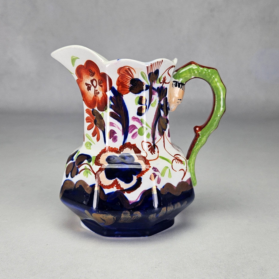 Allertons serpent handle jug with coloured flowers and green handle