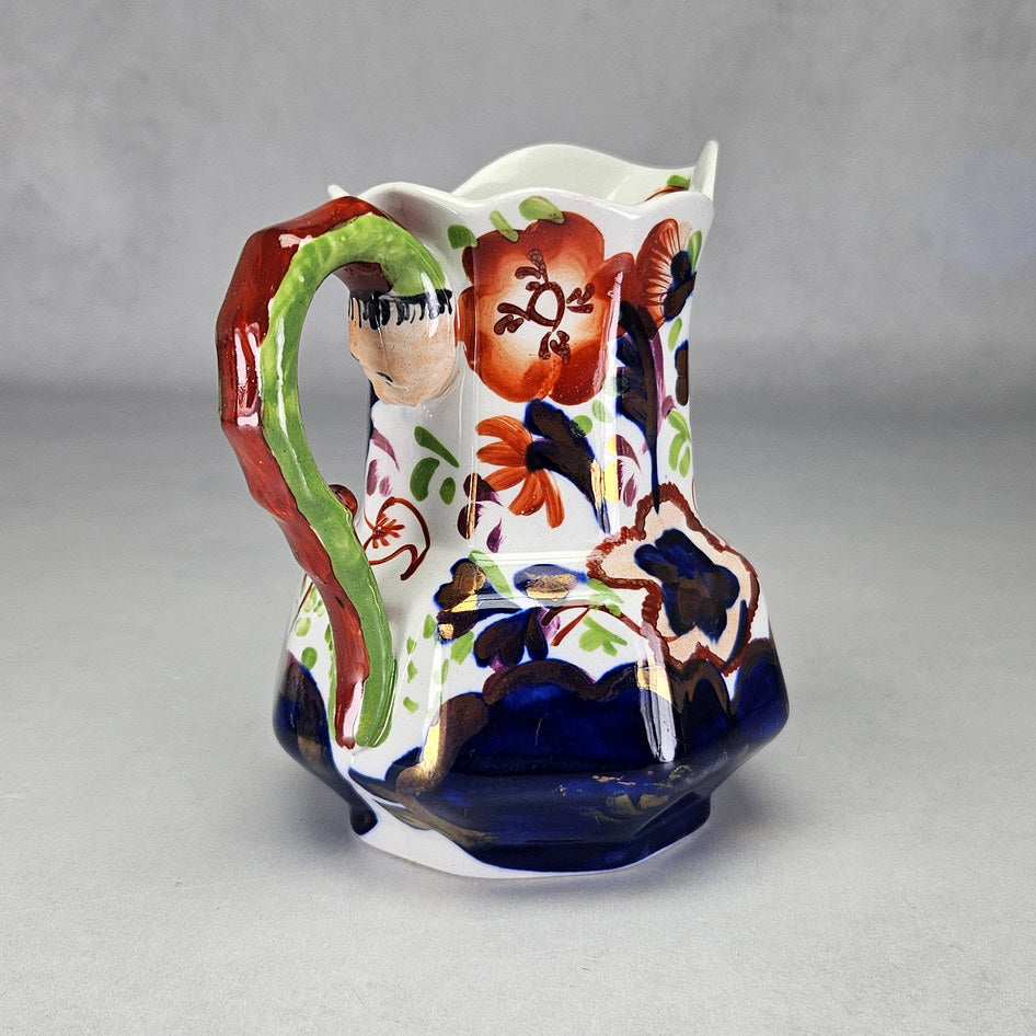 Allertons serpent handle jug showing coloured flowers and green handle