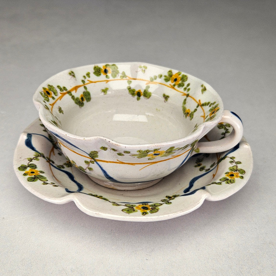 Cantagalli maiolica cup and saucer with yellow painted flowers