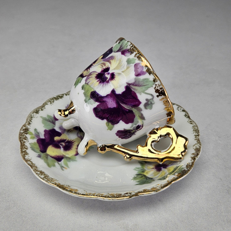 Side view of tripod pansy cup and saucer